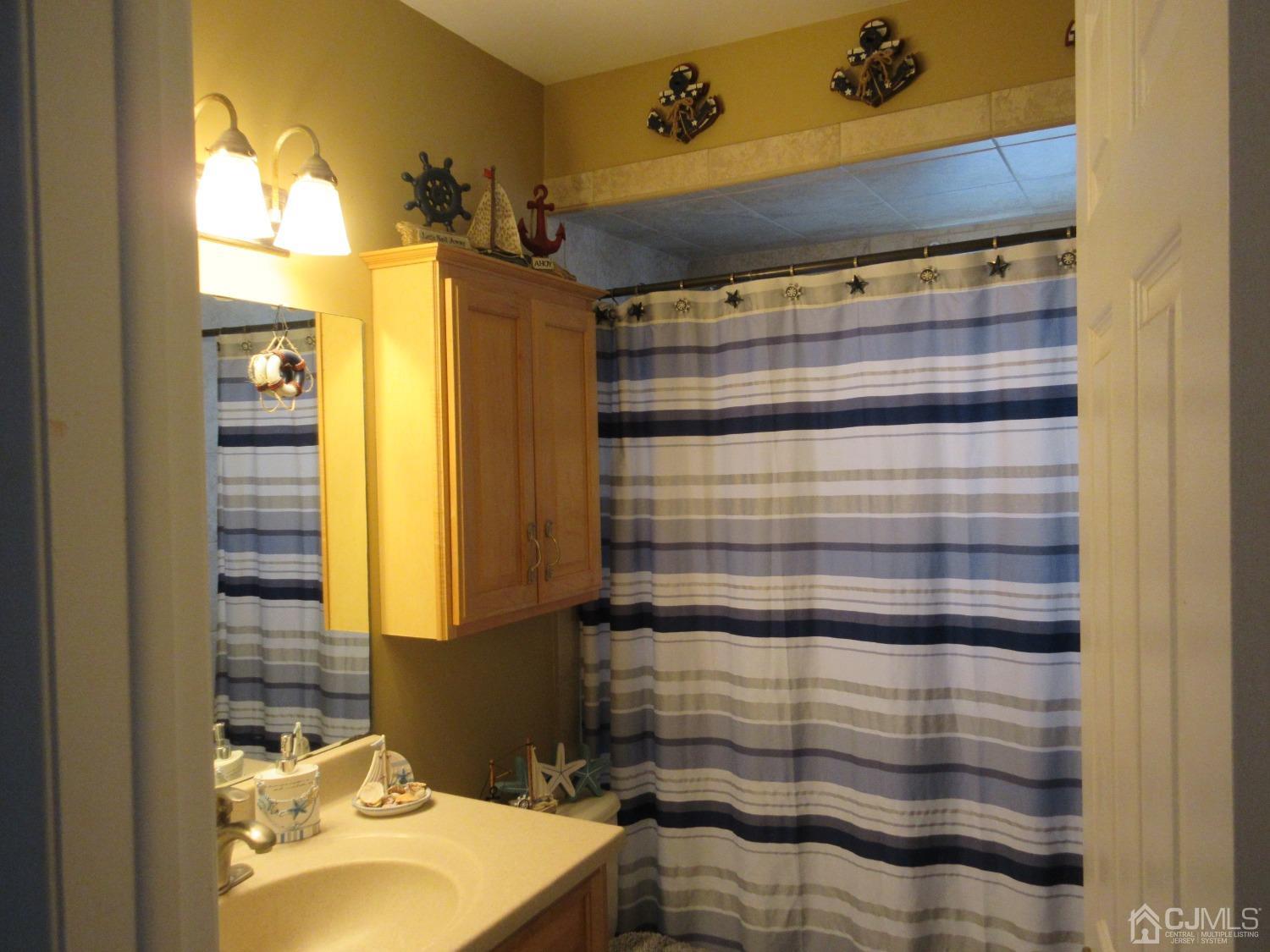406 Chestnut Street Middlesex, NJ 08846 - Photo 12 of 16 a bathroom with a sink and a mirror
