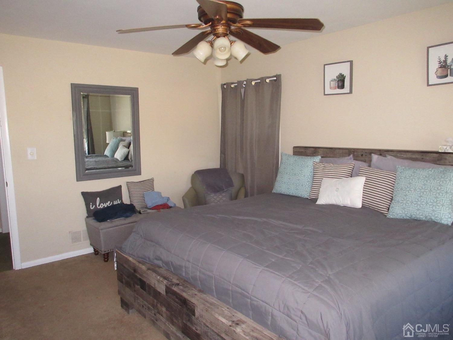 406 Chestnut Street Middlesex, NJ 08846 - Photo 13 of 16 a bedroom with a bed and a chandelier