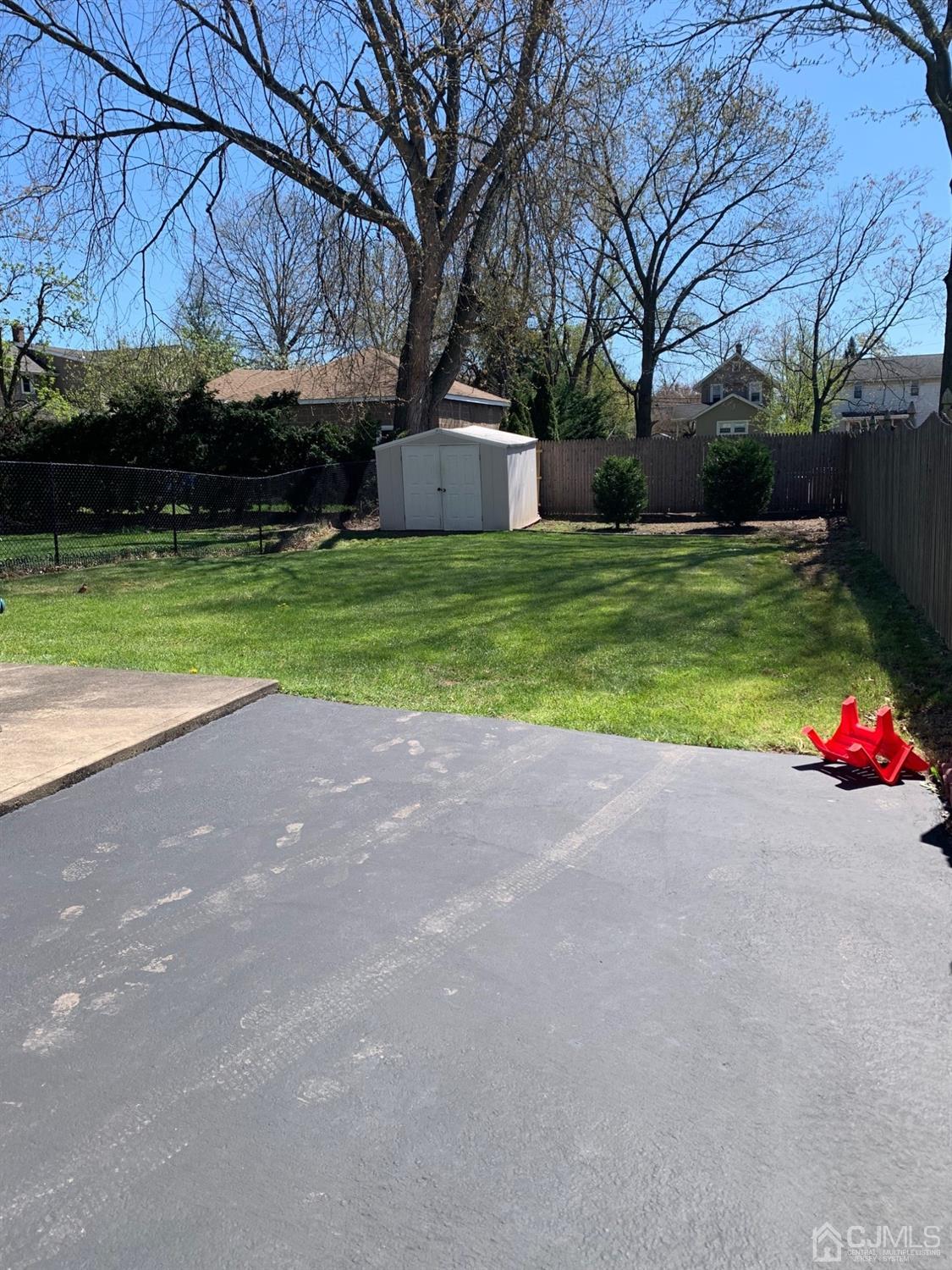 406 Chestnut Street Middlesex, NJ 08846 - Photo 15 of 16 a view of a house with a yard and garage