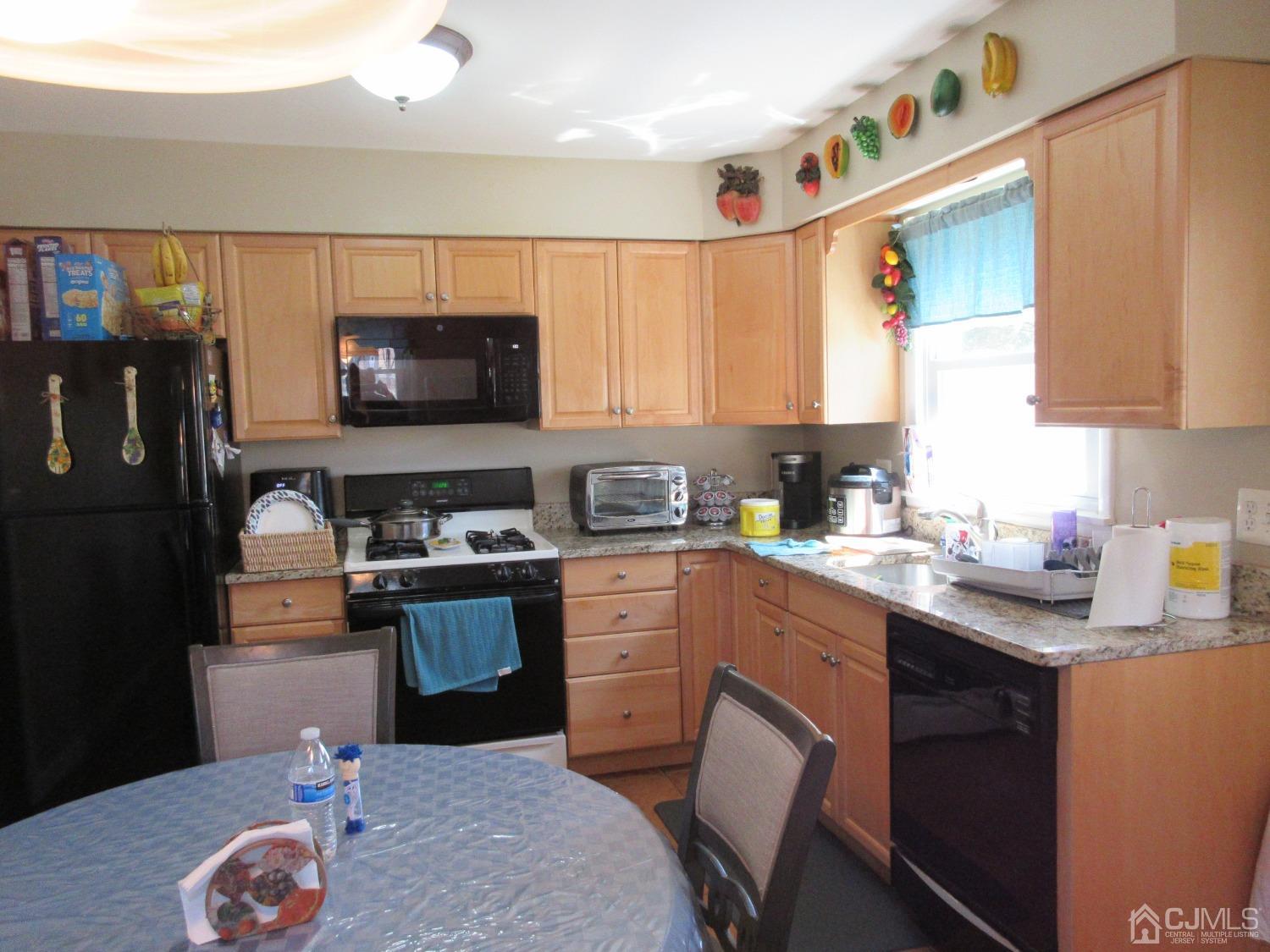 406 Chestnut Street Middlesex, NJ 08846 - Photo 5 of 16 a kitchen with stainless steel appliances granite countertop a sink stove and refrigerator