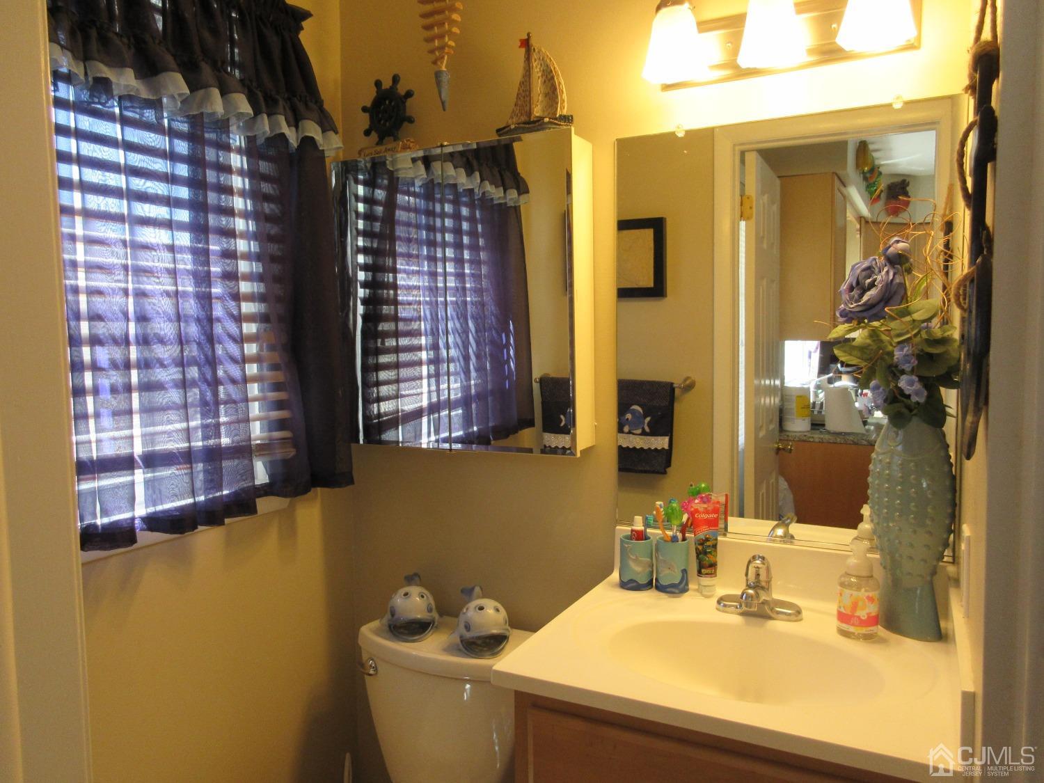 406 Chestnut Street Middlesex, NJ 08846 - Photo 7 of 16 a bathroom with a sink and a mirror
