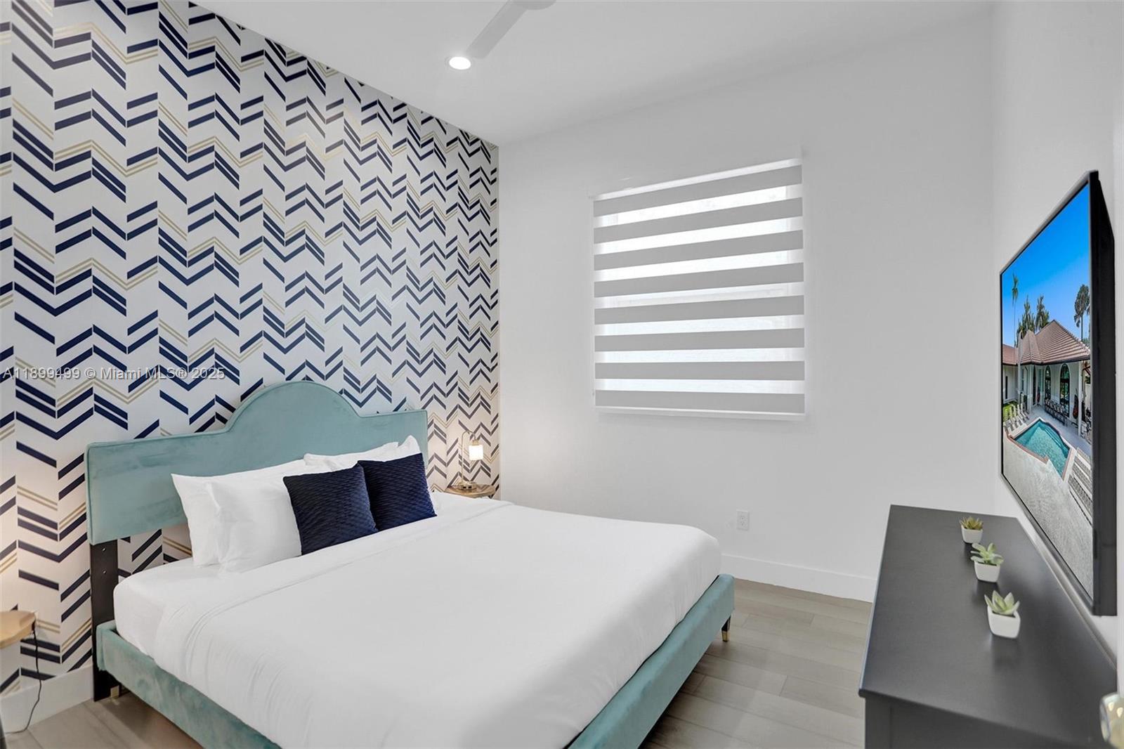 3152 Southwest 147th Avenue Davie, FL 33330 - Photo 20 of 38 a bedroom with a bed and a flat screen tv