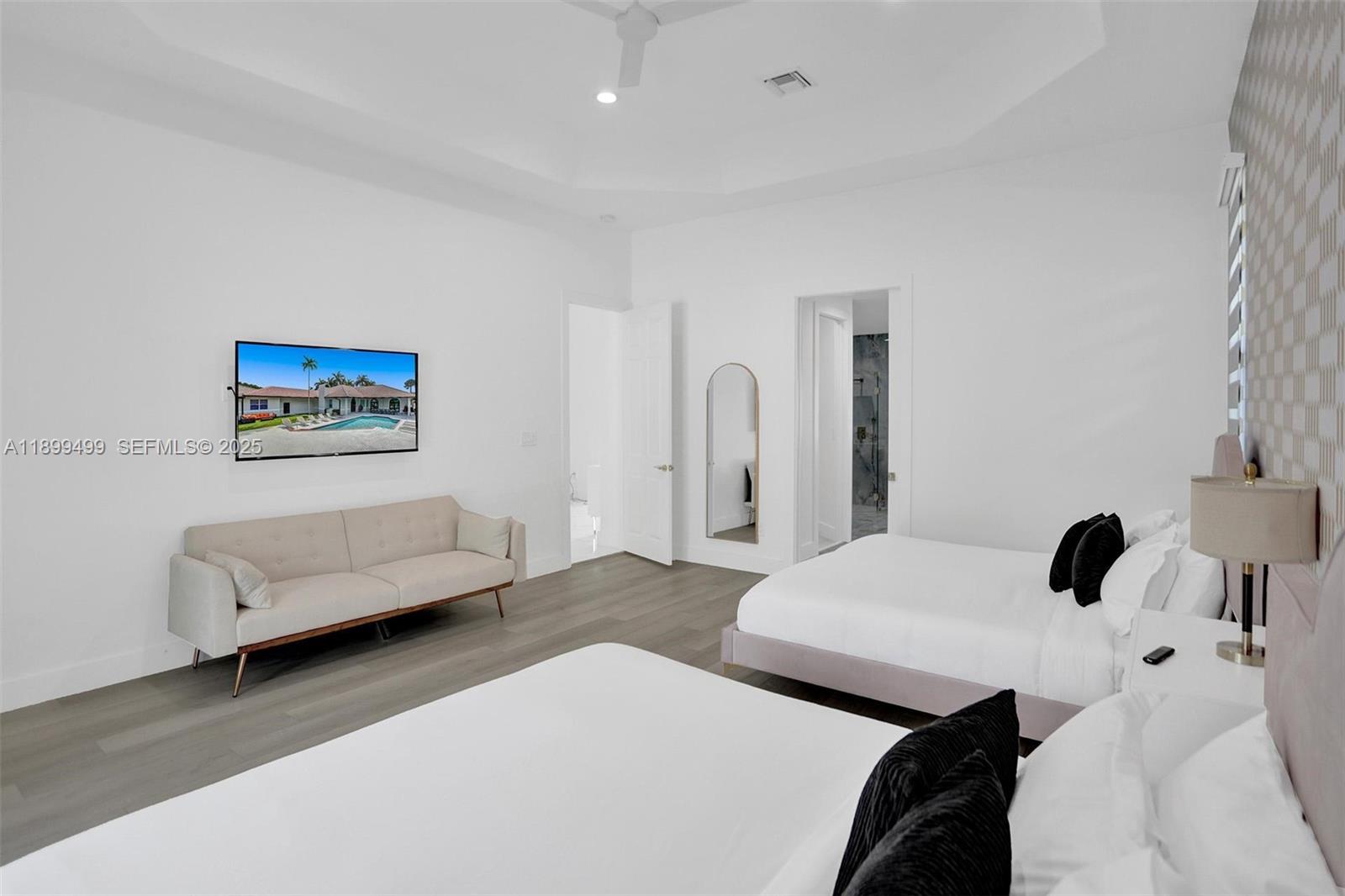 3152 Southwest 147th Avenue Davie, FL 33330 - Photo 23 of 38 a bedroom with a bed and a couch