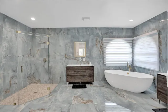 a spacious bathroom with a bathtub and shower