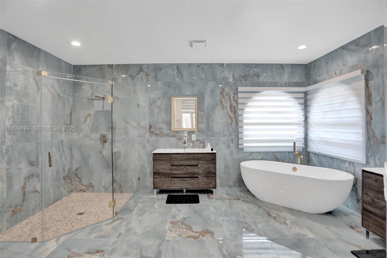 3152 Southwest 147th Avenue Davie, FL 33330 - Photo 24 of 38 a spacious bathroom with a bathtub and shower