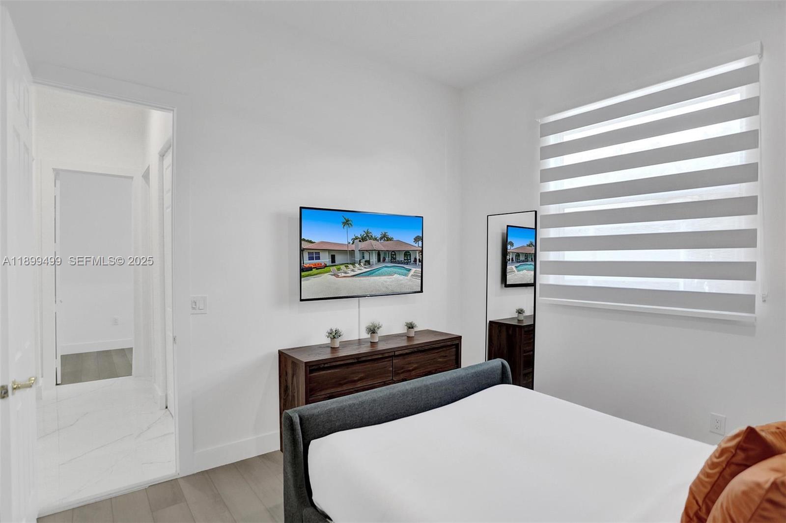 3152 Southwest 147th Avenue Davie, FL 33330 - Photo 29 of 38 a bedroom with a bed and a window