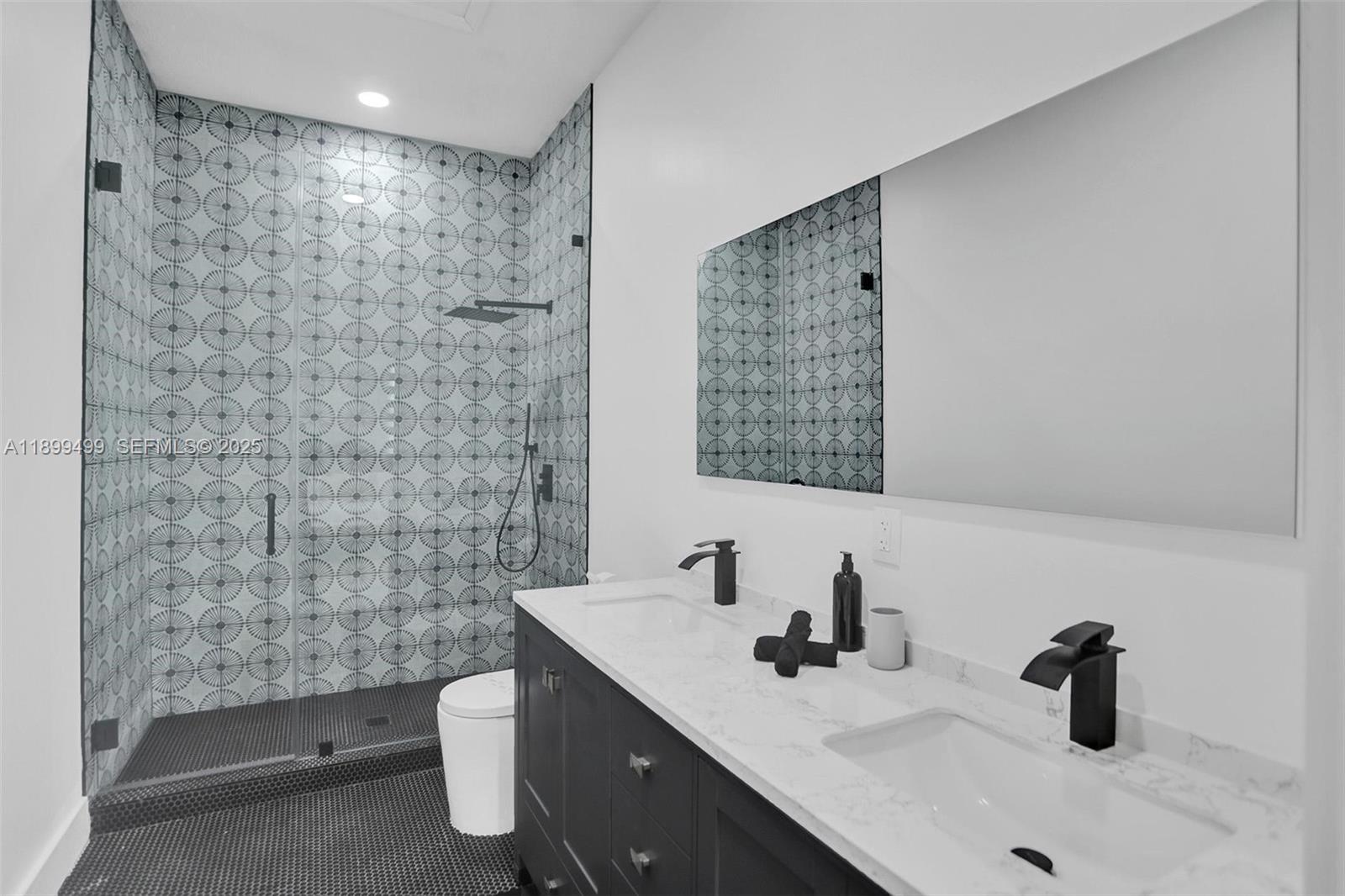 3152 Southwest 147th Avenue Davie, FL 33330 - Photo 32 of 38 a bathroom with a sink a toilet and mirror