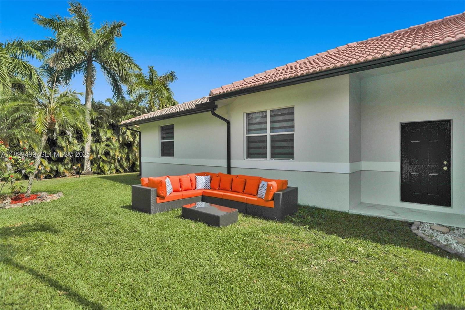 3152 Southwest 147th Avenue Davie, FL 33330 - Photo 36 of 38 a backyard of a house with table and chairs