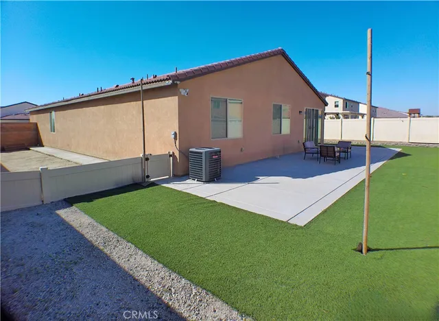 a front view of house with yard and outdoor seating