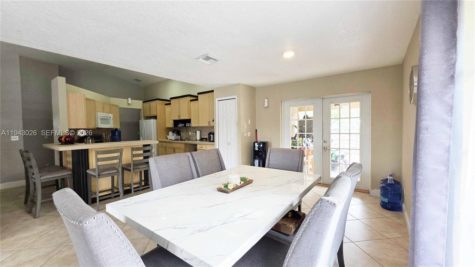 355 North Lindero Street Clewiston, FL 33440 - Photo 11 of 30 a large kitchen with a table and chairs