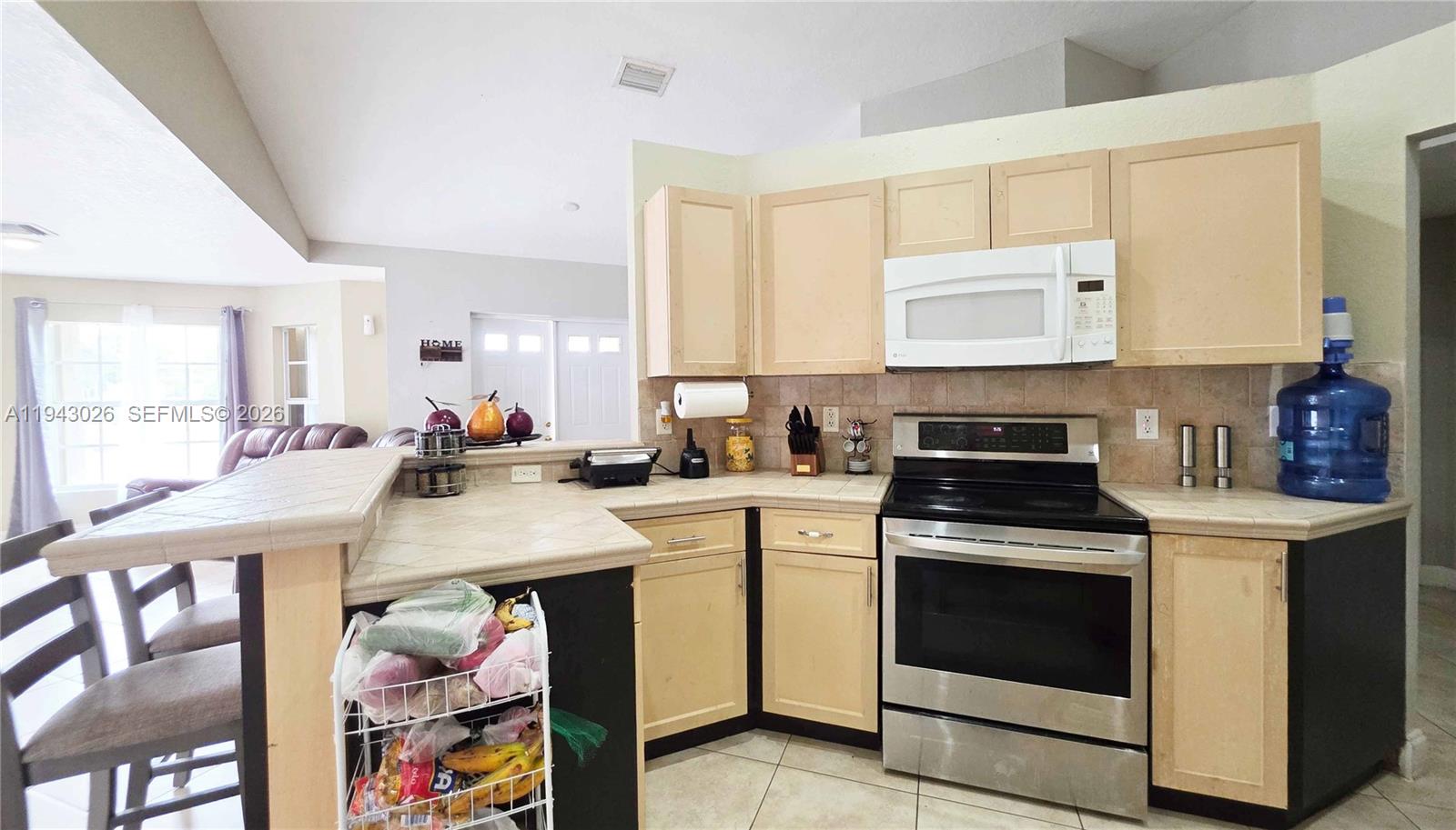 355 North Lindero Street Clewiston, FL 33440 - Photo 16 of 30 a kitchen with a stove a sink and a refrigerator