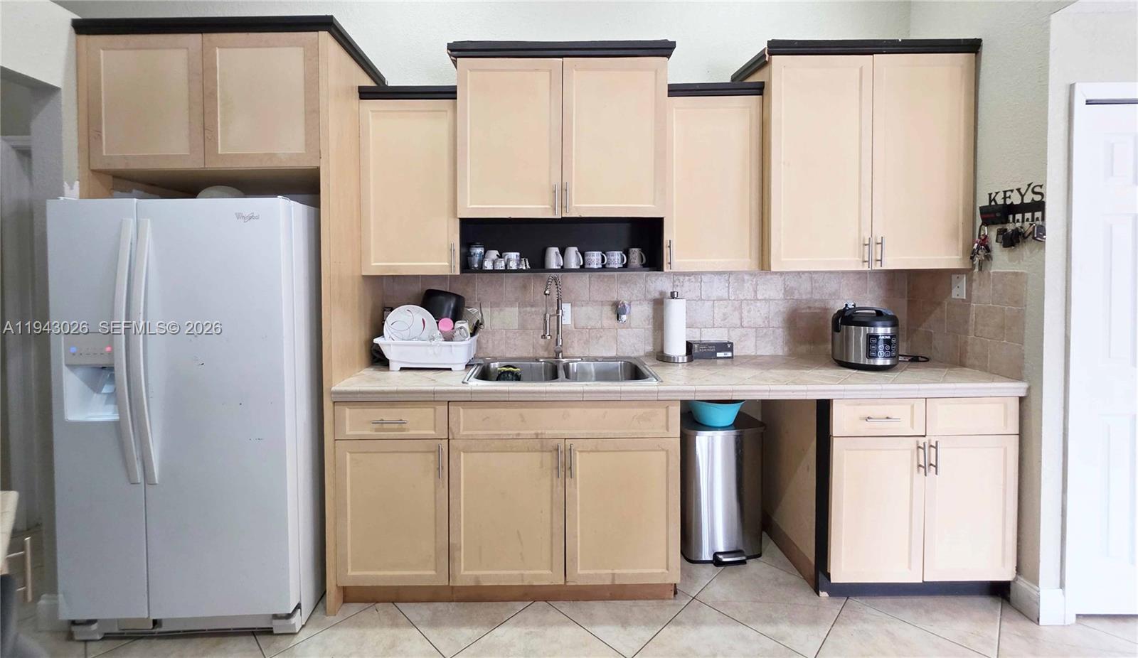 355 North Lindero Street Clewiston, FL 33440 - Photo 17 of 30 a kitchen with stainless steel appliances a refrigerator sink and cabinets