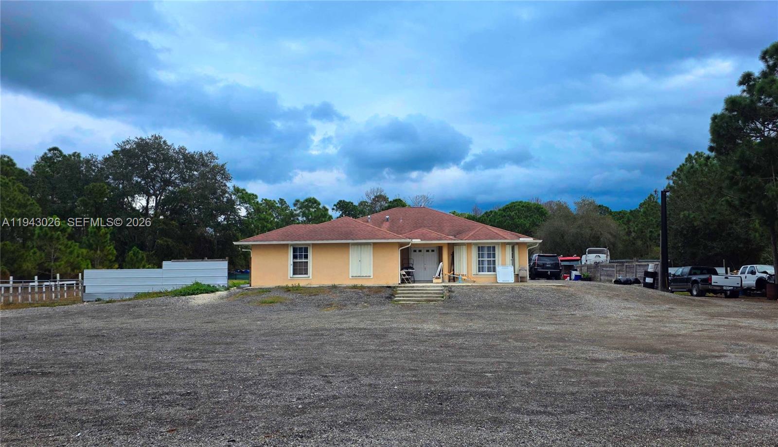 355 North Lindero Street Clewiston, FL 33440 - Photo 2 of 30 a view of a house with a yard and sitting area