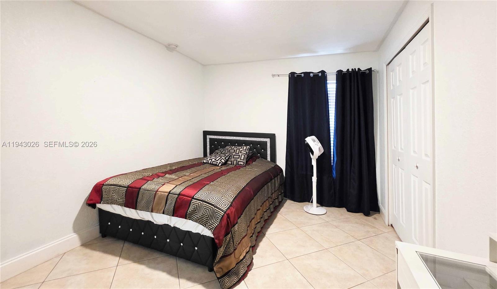 355 North Lindero Street Clewiston, FL 33440 - Photo 21 of 30 a bedroom with a bed and a mirror