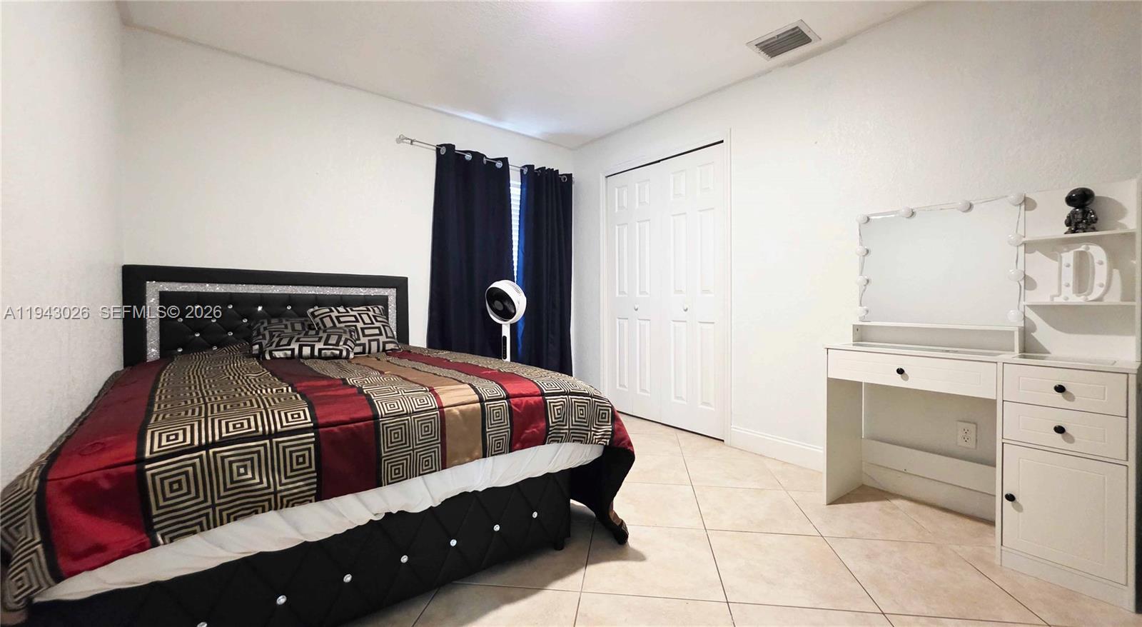 355 North Lindero Street Clewiston, FL 33440 - Photo 22 of 30 a bedroom with a bed and cabinets