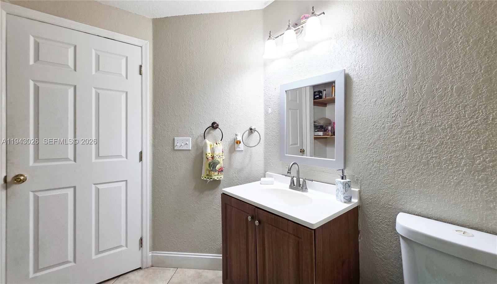 355 North Lindero Street Clewiston, FL 33440 - Photo 23 of 30 a bathroom with a sink and a mirror
