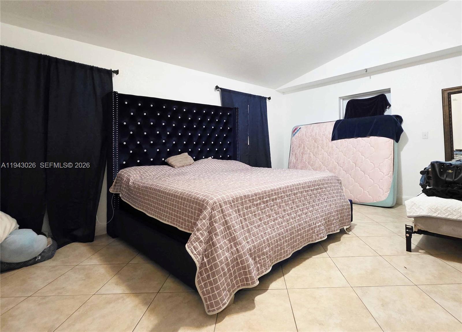 355 North Lindero Street Clewiston, FL 33440 - Photo 25 of 30 a bedroom with a bed and lamp