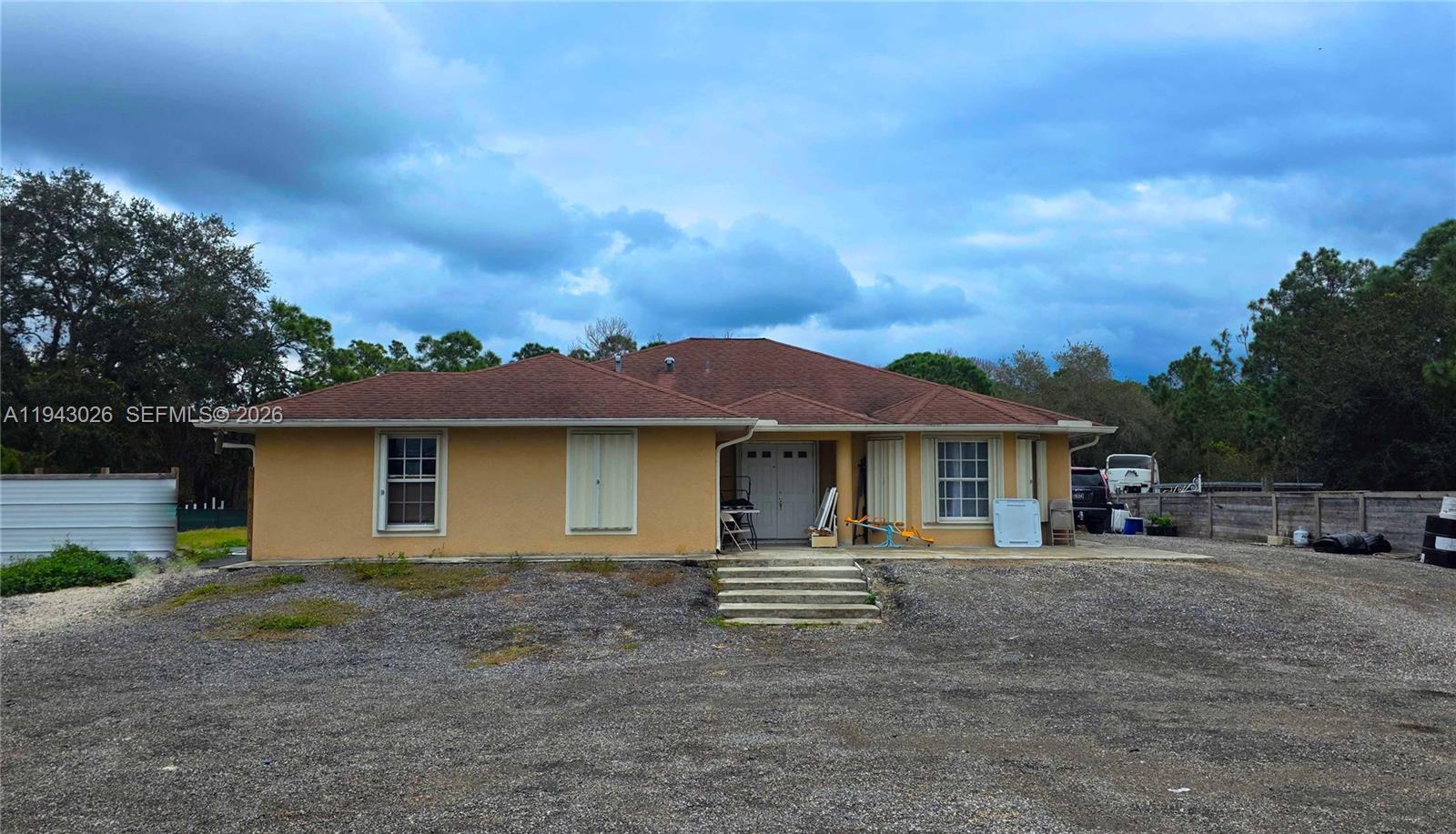 355 North Lindero Street Clewiston, FL 33440 - Photo 3 of 30 a front view of a house with a yard