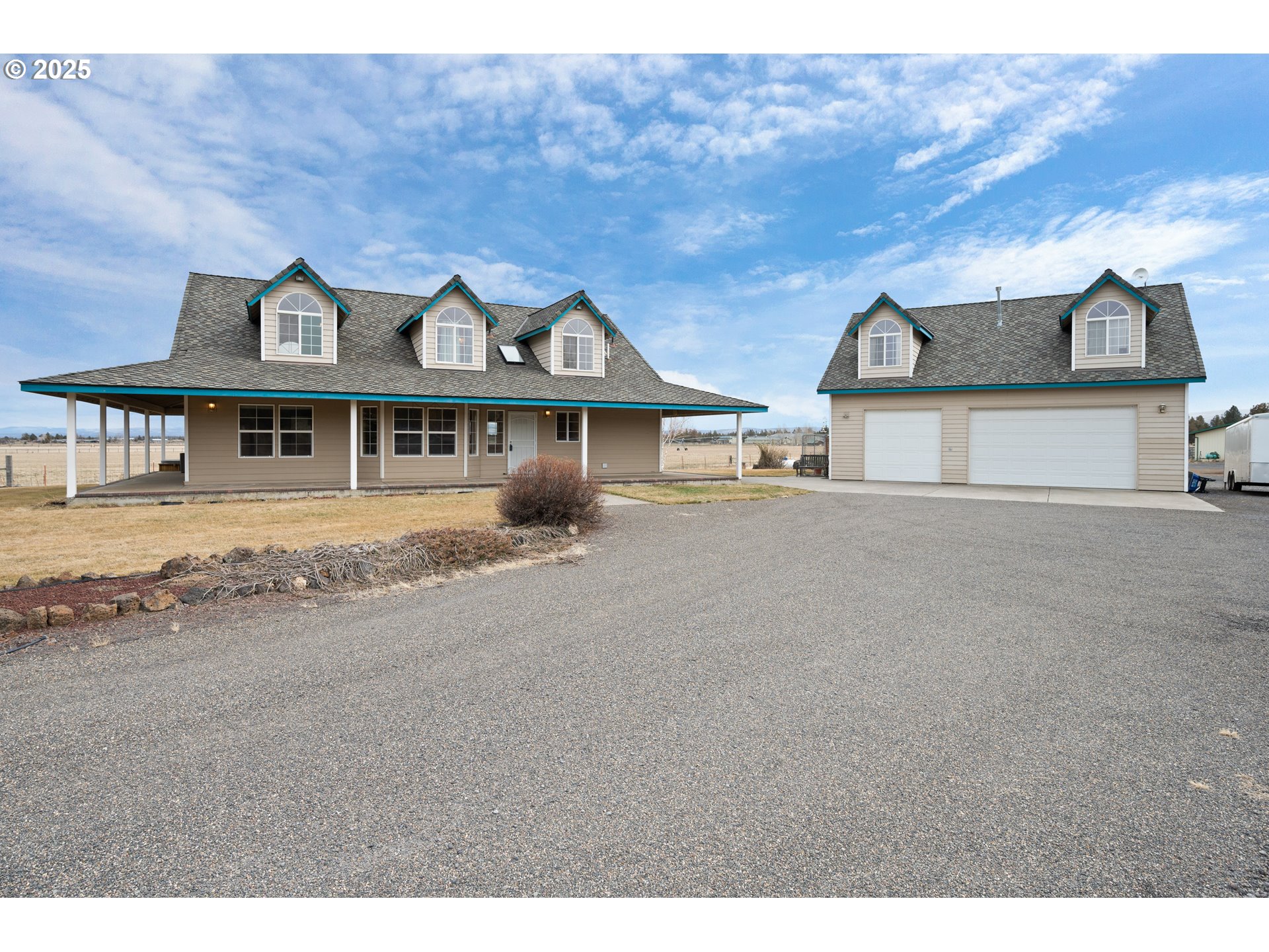 a view of a big house with a big yard and large tree