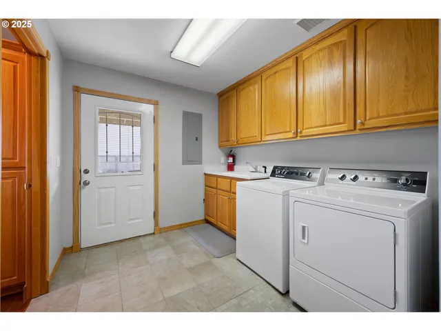 a view of storage and utility room with washer and dryer