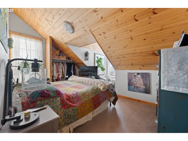 a bed room with a bed mirror and a night stand