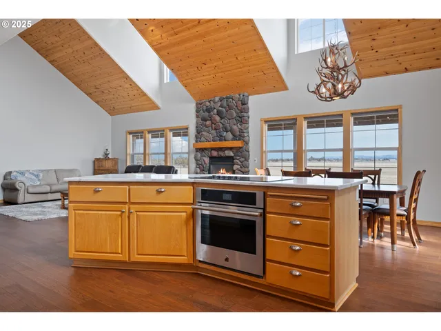 a kitchen with a stove a sink a dining table and chairs