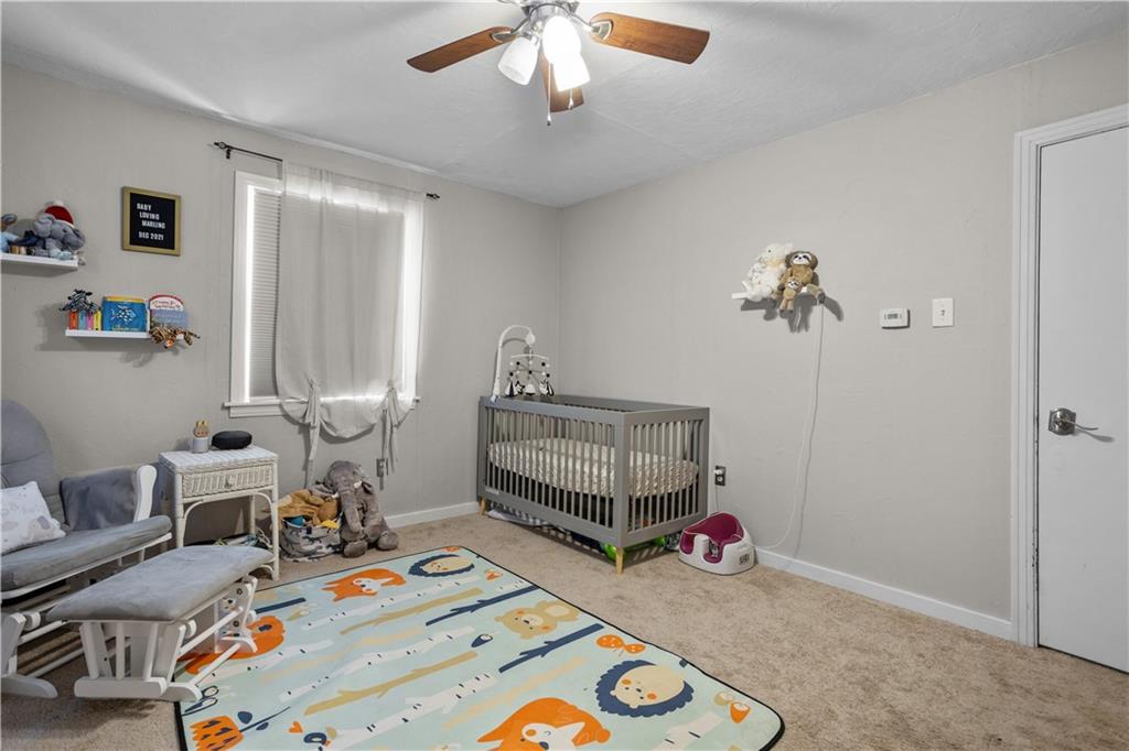 1129 Edith Avenue Pittsburgh, PA 15236 - Photo 15 of 25 a bedroom with bed and a chandelier