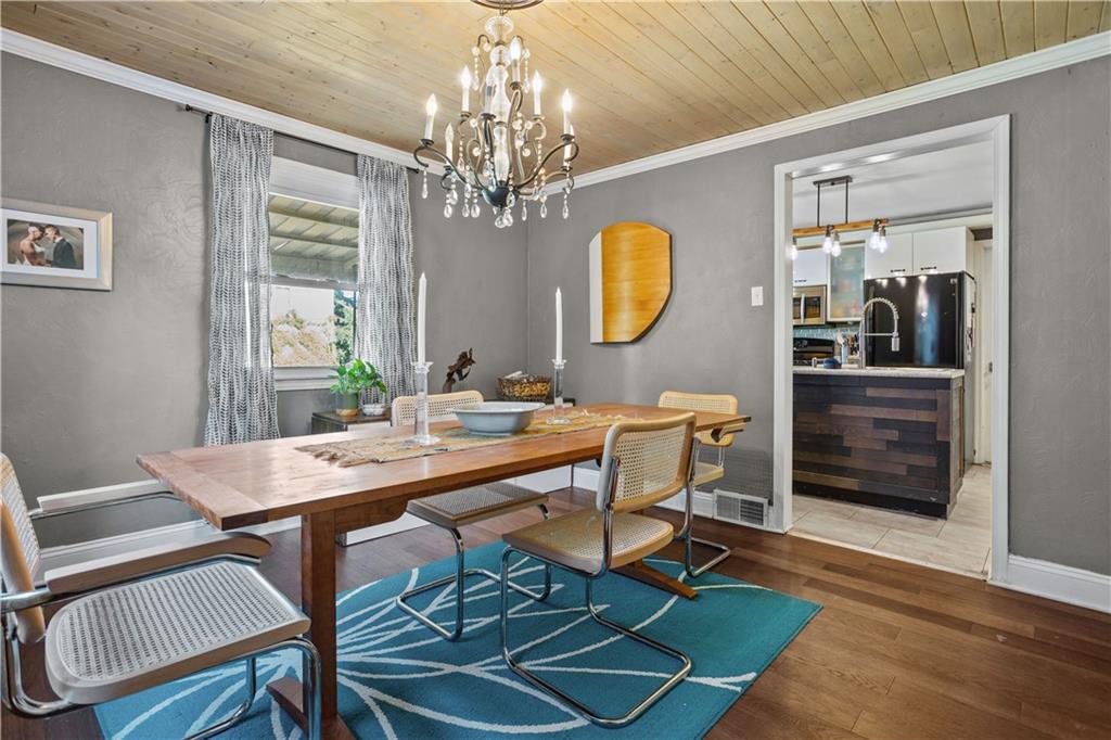 1129 Edith Avenue Pittsburgh, PA 15236 - Photo 9 of 25 a view of a dining room with furniture a chandelier and wooden floor