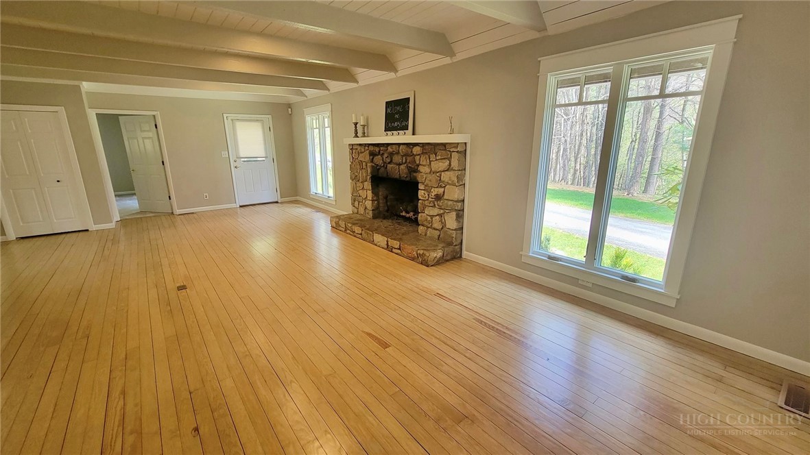 172 Yarrow Lane Boone, NC 28607 - Photo 3 of 30 a view of empty room with wooden floor and fireplace