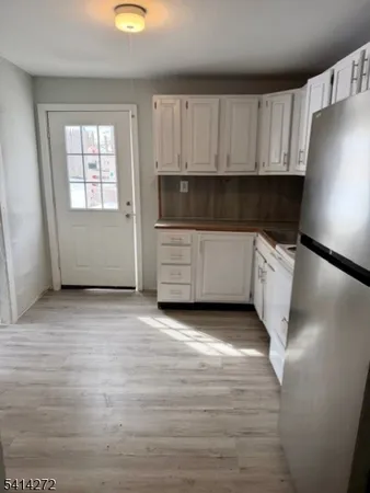 a kitchen with wooden cabinets and a stove
