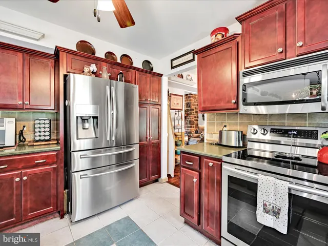 a kitchen with stainless steel appliances and refrigerator