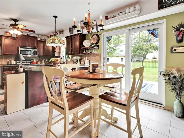 a dining room filled with furniture and chandelier
