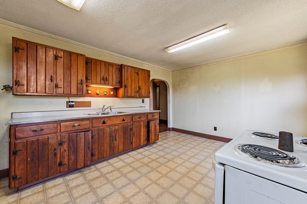 411 Old Highway 5 Blue Ridge, GA 30513 - Photo 23 of 45 a kitchen with stainless steel appliances granite countertop a sink stove and cabinets