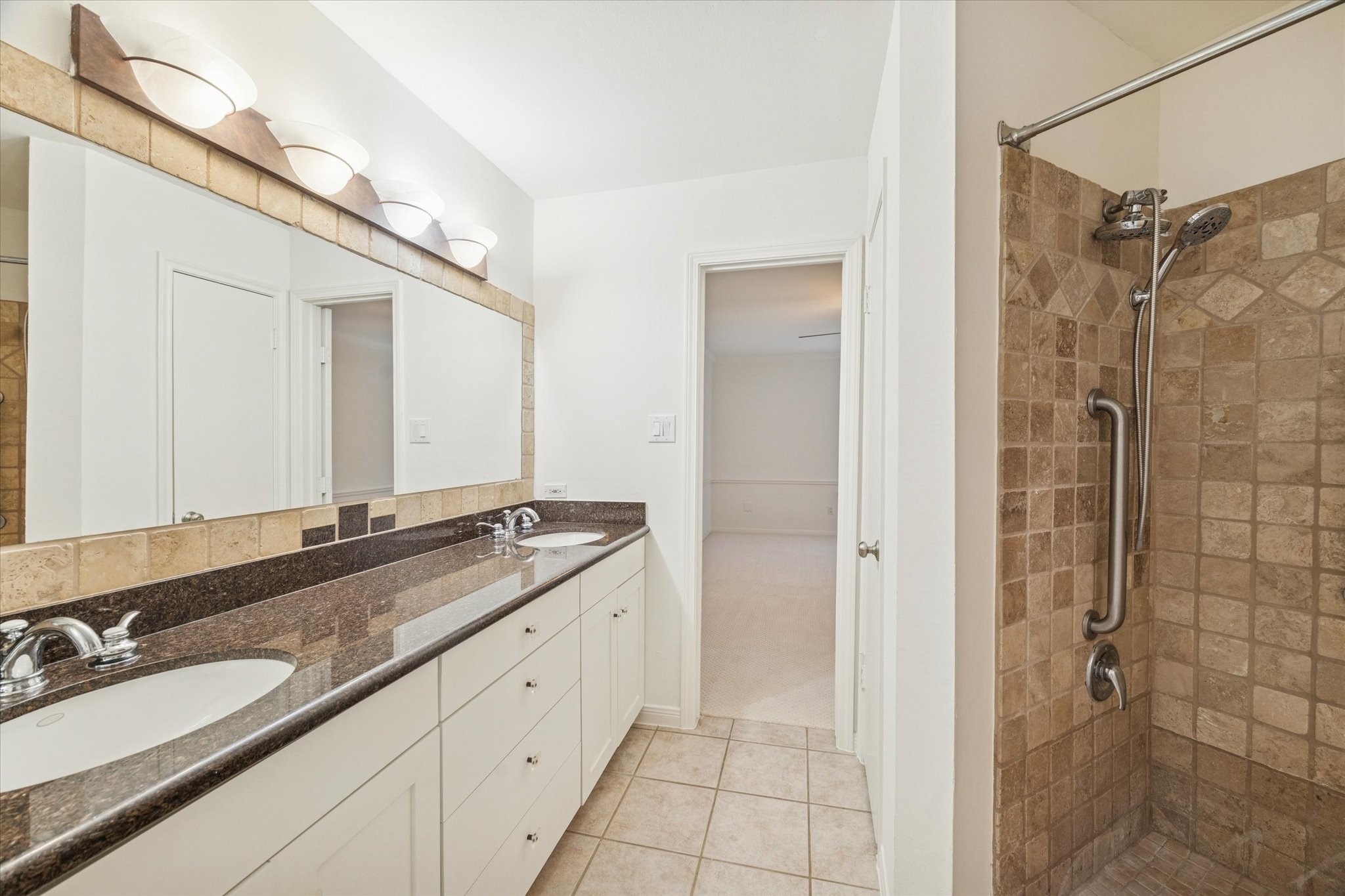 12 Lakeridge Drive Spring, TX 77381 - Photo 11 of 24 Modern walk-in shower with full-height stone tile and premium fixtures, creating a spa-like retreat in the primary bath.