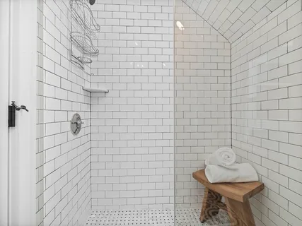 a spacious bedroom with a bed and wooden floor