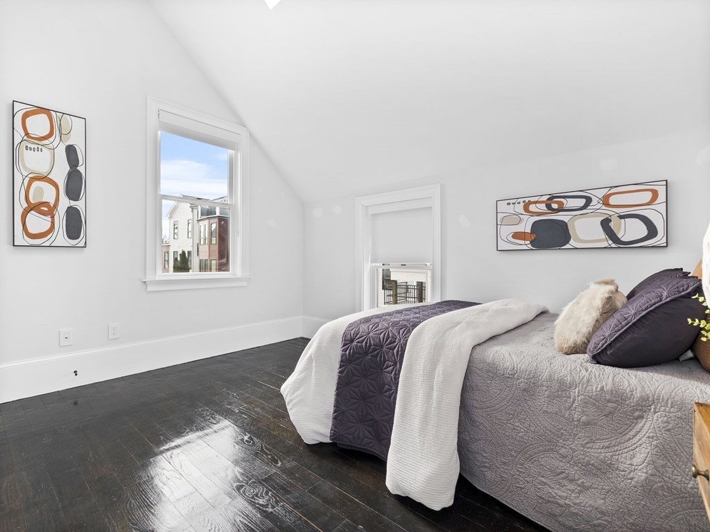 131 Centre Street Boston, MA 02124 - Photo 21 of 26 a bedroom with a bed and painting on the wall