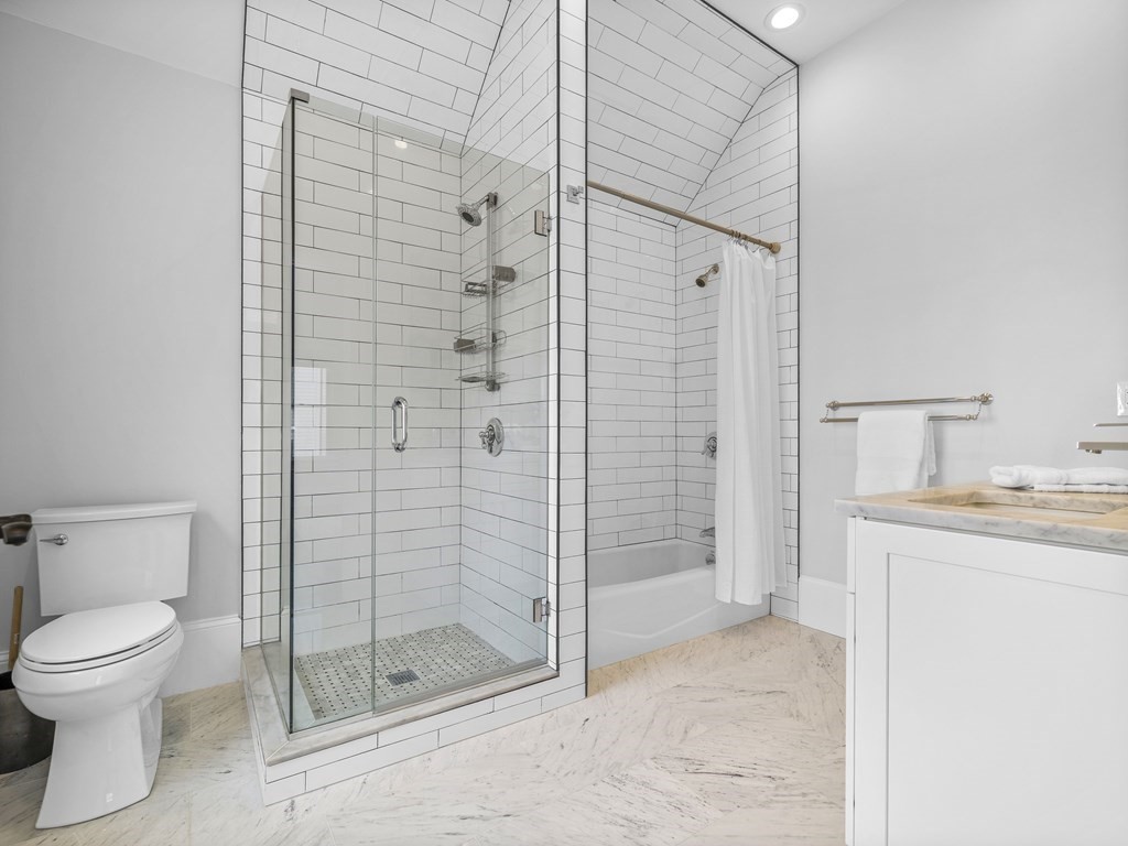 131 Centre Street Boston, MA 02124 - Photo 22 of 26 a bathroom with a shower toilet and sink