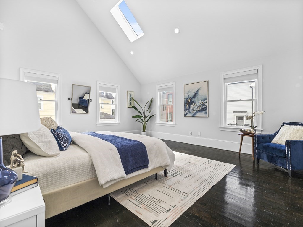131 Centre Street Boston, MA 02124 - Photo 26 of 26 a bedroom with a bed and wooden floor