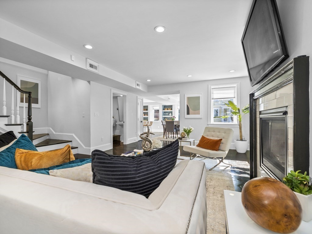 131 Centre Street Boston, MA 02124 - Photo 3 of 26 a living room with furniture and a wooden floor