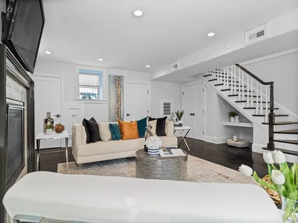 a living room with furniture and wooden floor