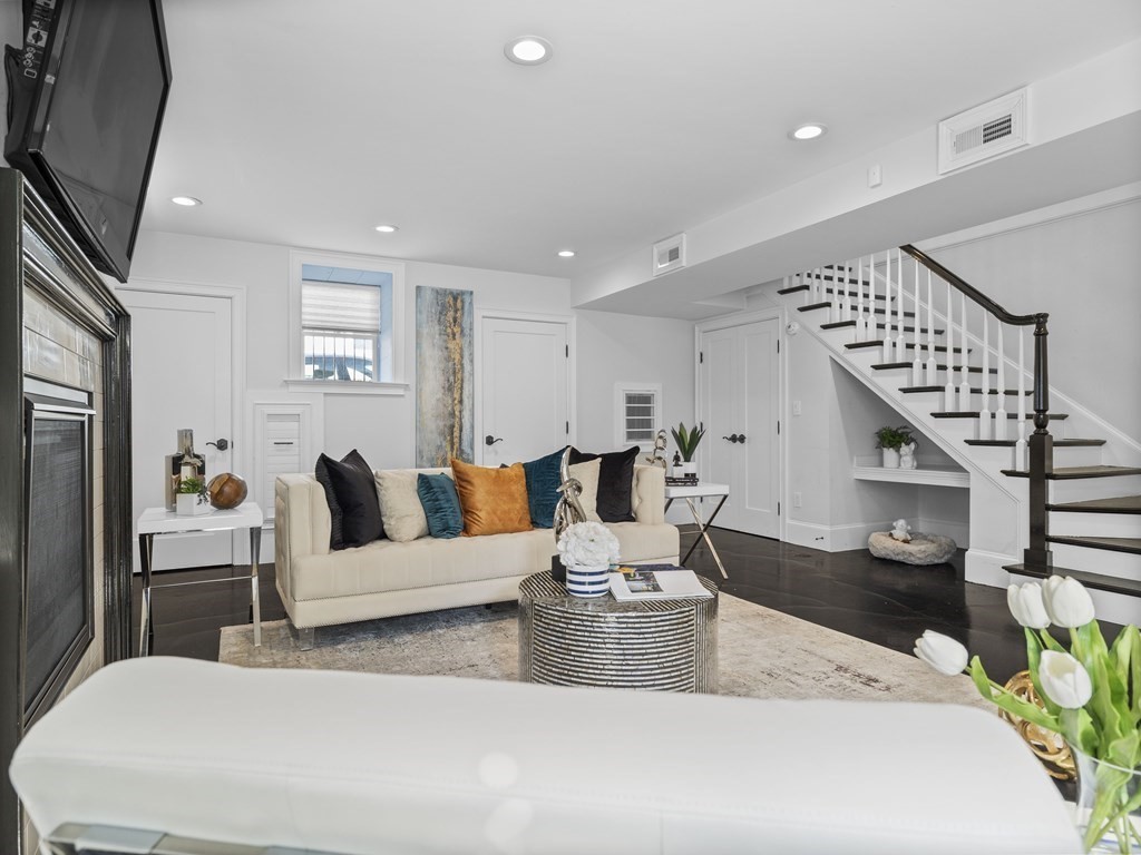 131 Centre Street Boston, MA 02124 - Photo 4 of 26 a living room with furniture and wooden floor