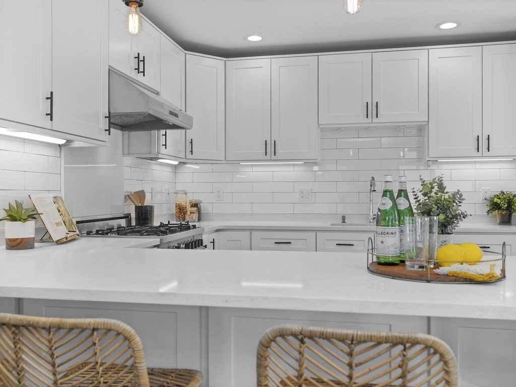 131 Centre Street Boston, MA 02124 - Photo 7 of 26 a kitchen with a sink a white cabinets and appliances