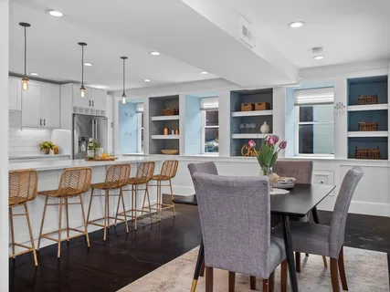 a dining room with furniture window and wooden floor