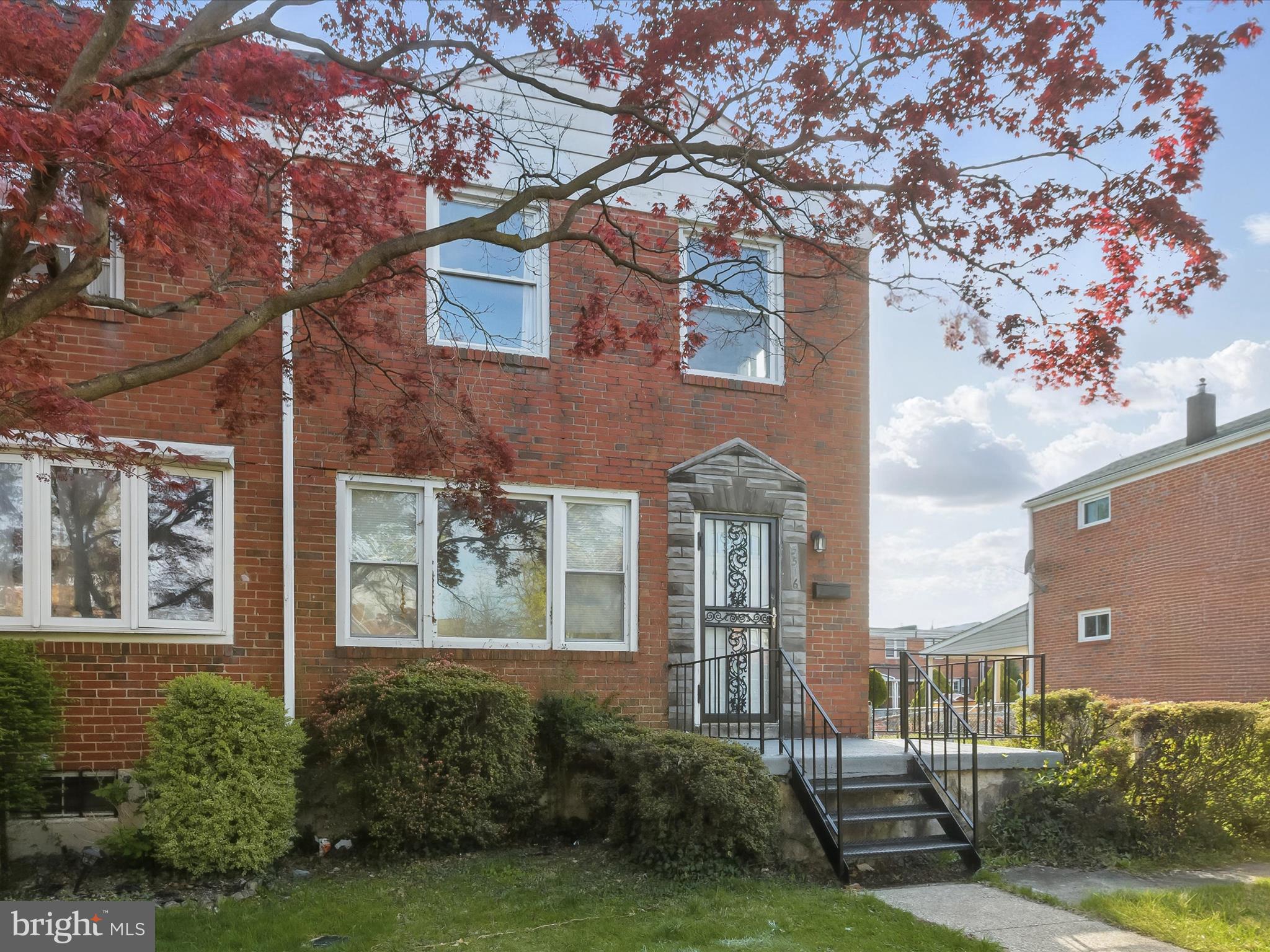 5516 Cedonia Avenue Baltimore, MD 21206 - Photo 1 of 28 a view of a brick house with a yard and plants