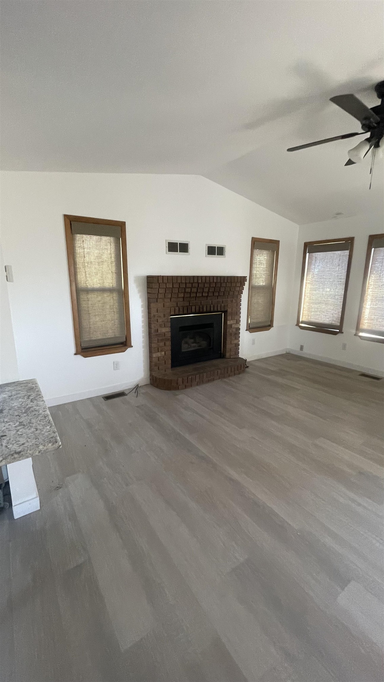 3374 G Road Clifton, CO 81520 - Photo 14 of 24 a view of an empty room with a fireplace and window