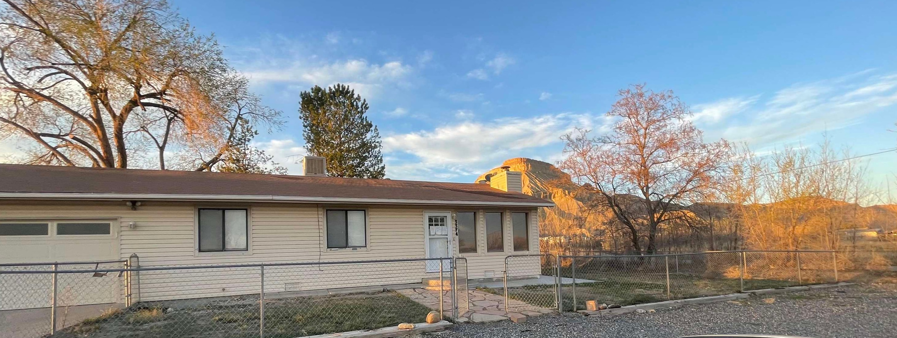 3374 G Road Clifton, CO 81520 - Photo 22 of 24 a front view of a house with a yard and garage