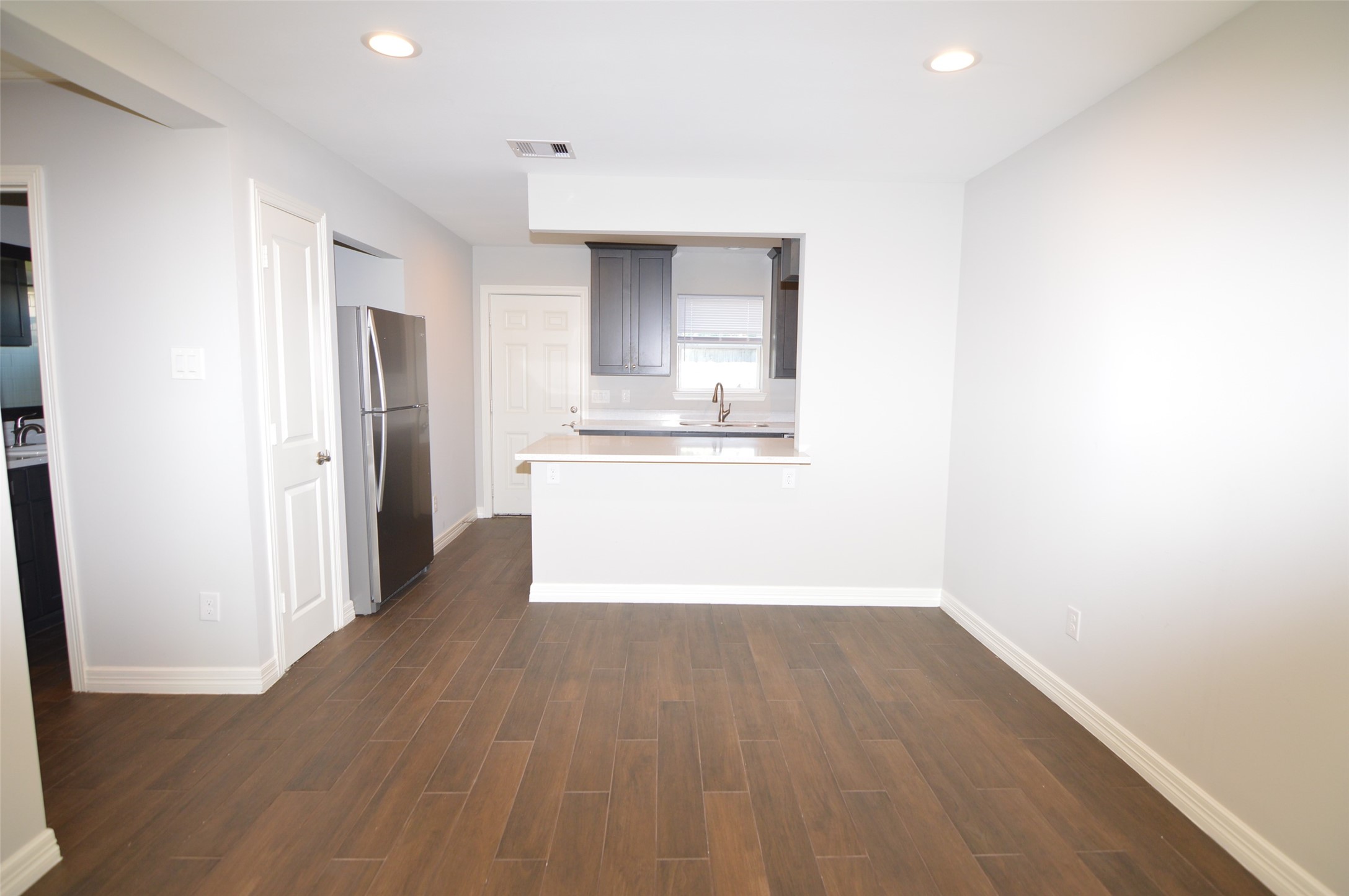 10002 Neuens Road, Unit 2 Houston, TX 77080 - Photo 3 of 15 a view of a kitchen with wooden floor and a sink
