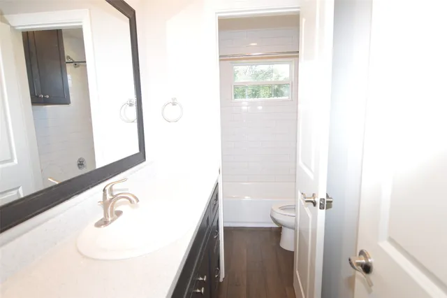 a bathroom with a sink a toilet and a mirror