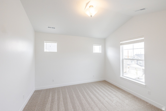 693 West 4500th South, Unit O302 Mapleton, UT 84664 - Photo 10 of 16 Empty room featuring light colored carpet and vaulted ceiling