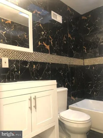 a bathroom with a toilet a sink and a shower